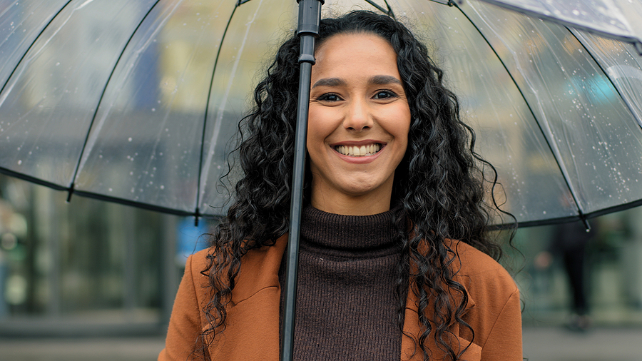 Woman smiling in the rain in Kahului and [test_shortcode]